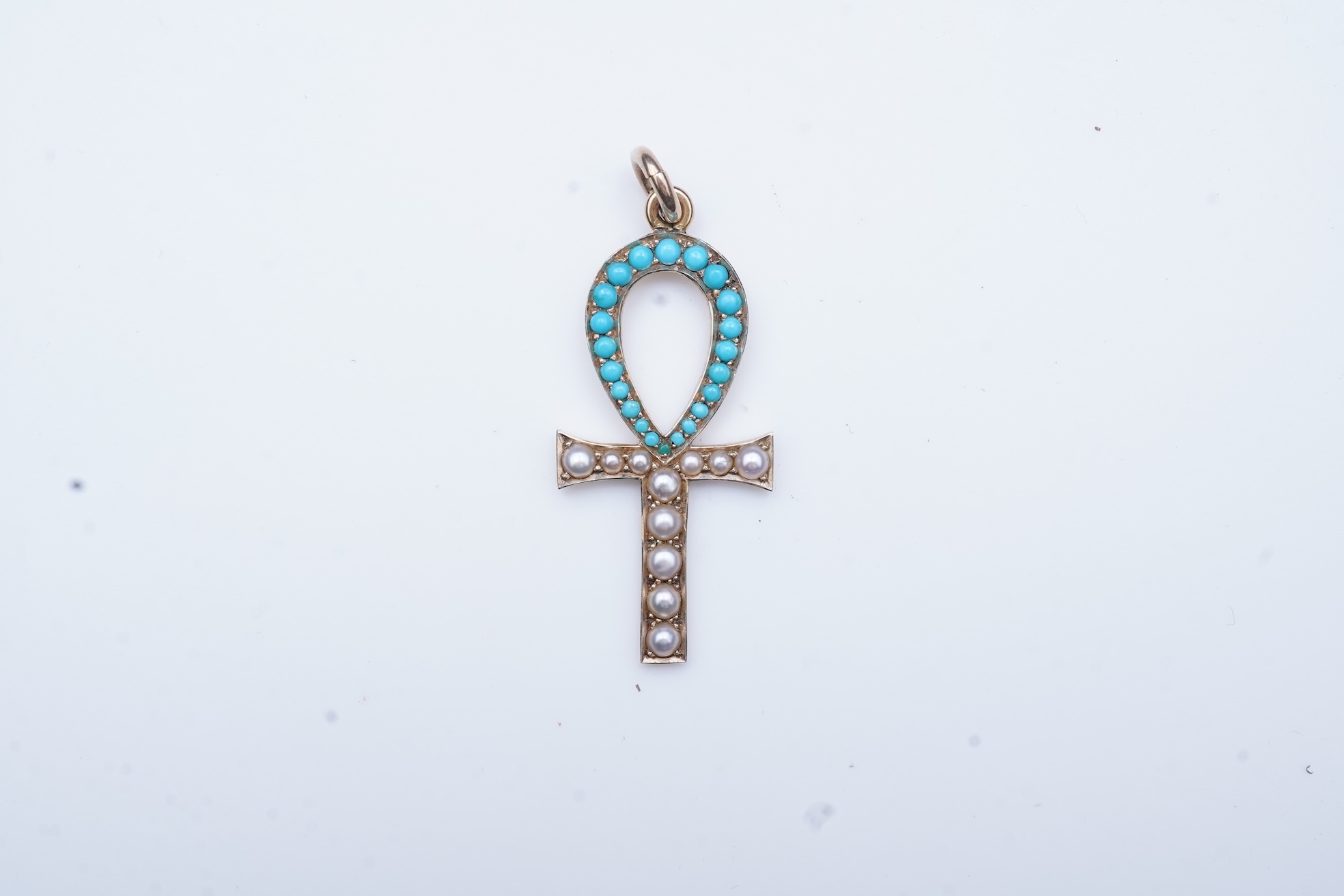 An Edwardian Egyptian revival turquoise and pearl pendant, early 20th century